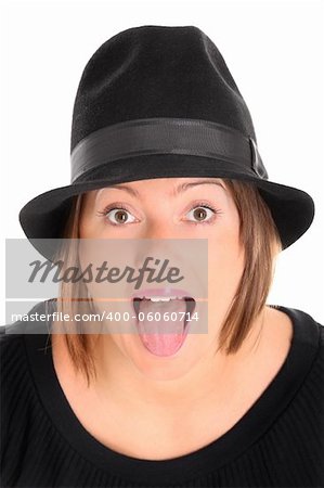 A portrait of a pretty young woman in a black hat sticking out tongue over white background