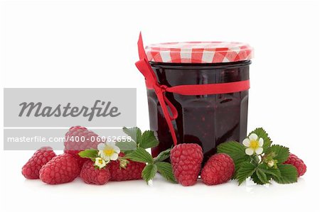 Raspberry jam with fresh raspberries, blossom and leaf sprigs over white background.