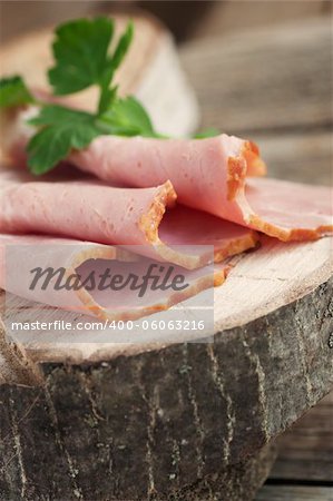 Fresh pork ham with garnish on wooden background