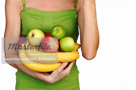 woman holds a pile of fruit on a white background