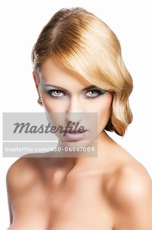 blond beautiful woman with strong make up and an old fashion hair stylish in beauty portrait close up. She looks in to the lens with actractive expression and her mouth is slightly open