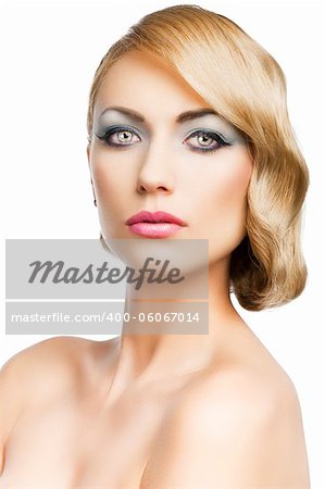 blond beautiful woman with strong make up and an old fashion hair stylish in beauty portrait close up, she is in front of the camera and looks in to the lens, she is in front of the camera and looks in to the lens.