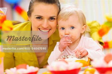 Happy mother and baby on first birthday celebration party