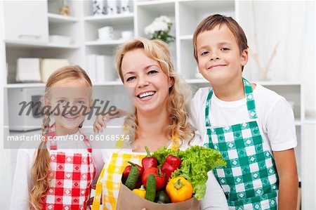 Happy people with healthy food in the kitchen