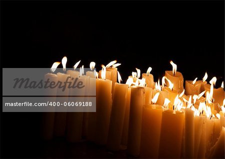 Lighted church candles in dark