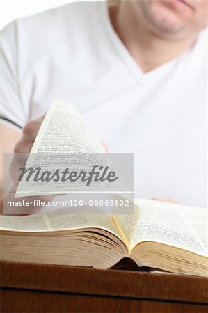Man turning the page of the Bible. Shallow dof