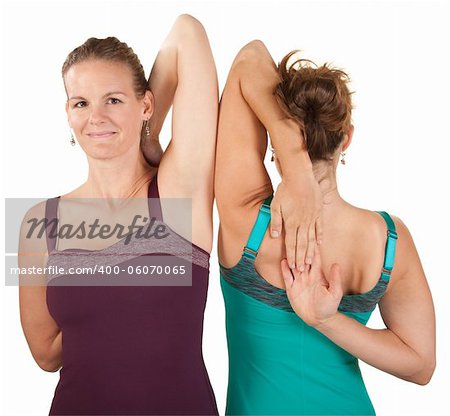 Two women stretch their shoulders over white background