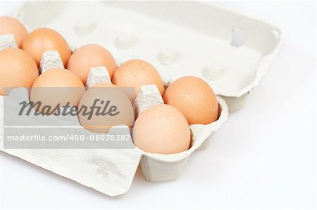 Fresh eggs in carton box on white background