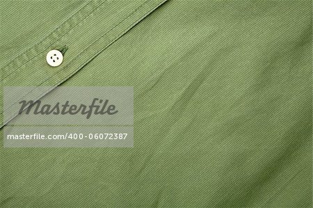 Green fabric texture with a button background