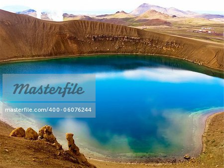 Blue crystal lake with clouds reflected inside