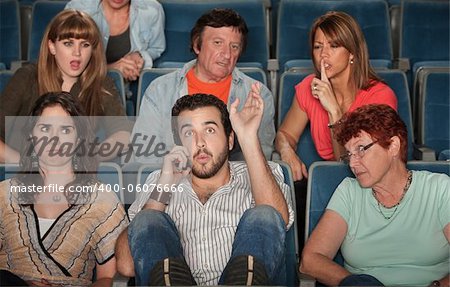 Loud bearded man on phone annoys the audience in theater