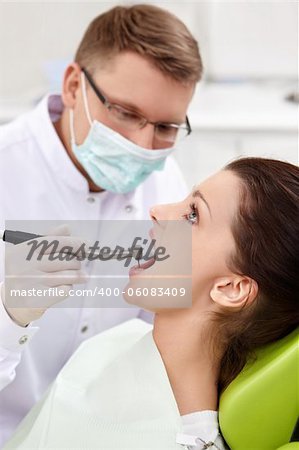 The dentist treats teeth of the patient in the clinic