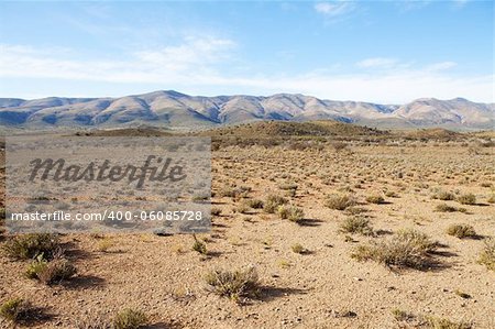 Semi-desert region in South Africa with mountains and blue sky