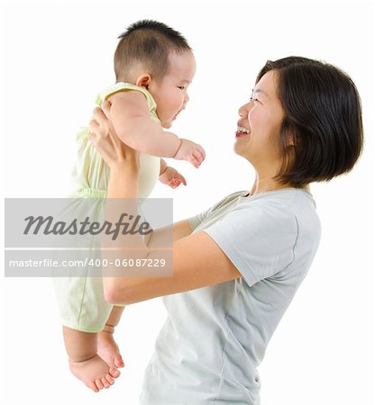 Asian mother playing with her baby boy