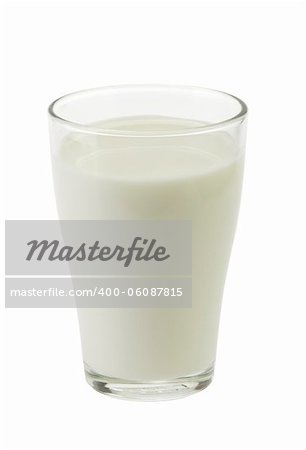 milk is poured into a glass on a white background isolated