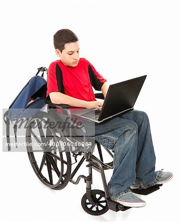 Disabled teen boy using a laptop computer.  Full body isolated on white.
