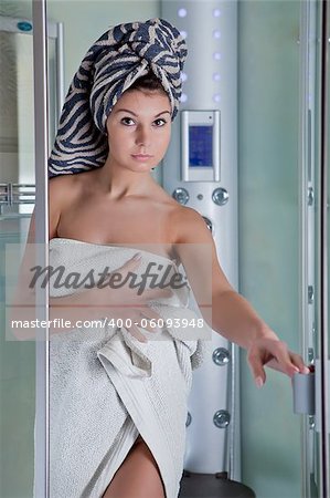 Beautiful smiling girl after a shower in a white towel