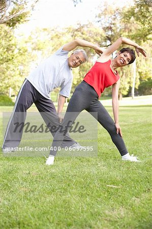 Senior Couple Exercising In Park