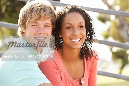 Teenage Couple Sitting In Playground