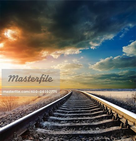 railway to horizon under dramatic sky