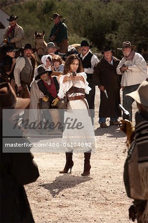 Sexy Latina woman in western outfit with pistol