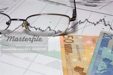 Glasses and Euro on graph of charts.