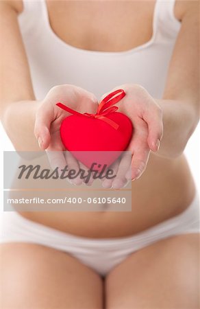 Healthy woman holding heart in hands on white