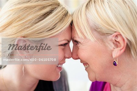 Women portrait with happy mom and daughter smiling, face to face, showing love and affection. Close up