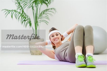 Happy healthy woman doing abdominal crunch