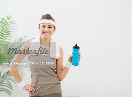 Portrait of smiling healthy woman with bottle of water