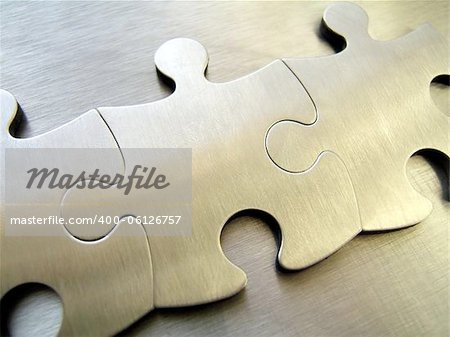 Three steel jigsaw close-up on a metallic background