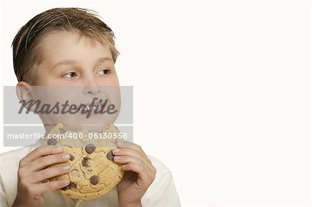 Boy with a choc chip cookie - space for copy