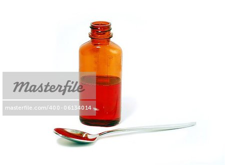 Bottle of cough syrup and a spoon on white background