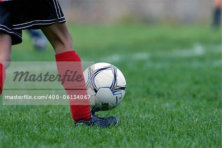 Closeup of a girl kicking the soccer ball