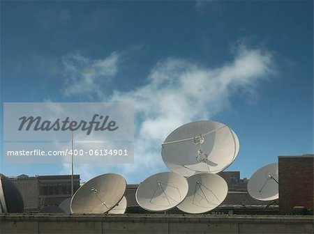 Satelite communications discs on top of building.