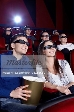 People watch a movie in 3D glasses in the cinema