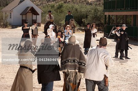 Group of cowboys and gunfighters in an old west shoot out