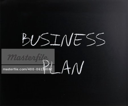 "Business plan" handwritten with white chalk on a blackboard.