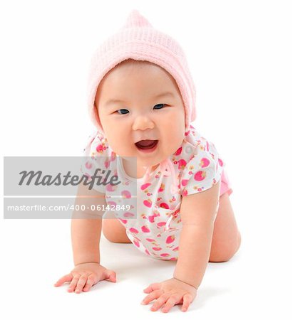 Six months old baby girl crawling over white background