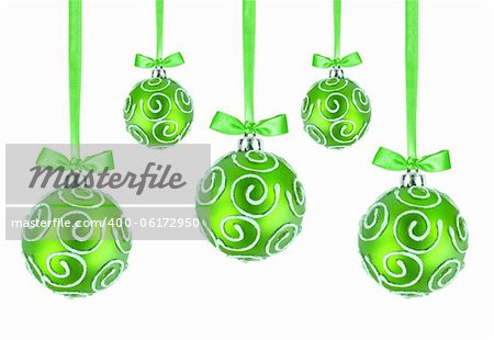 Green Christmas balls with bows on white background