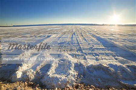 heap of salt on the surface of the salt lake at sunset