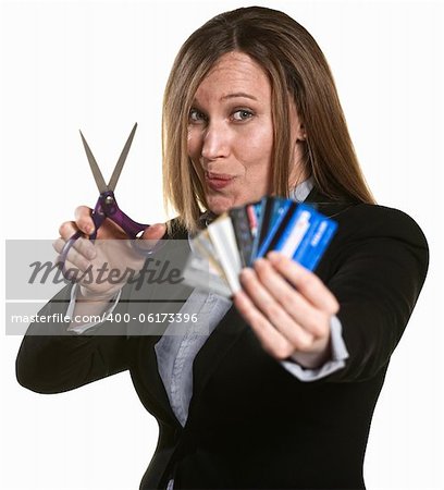 Businesswoman with scissors and stack of credit cards