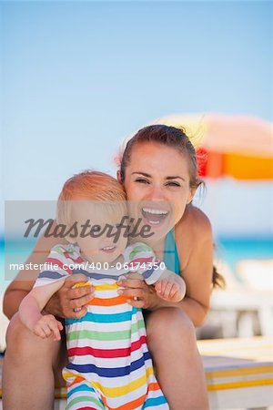 Portrait of happy mother and baby on beach