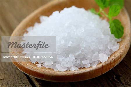 white  large sea salt in a wooden spoon