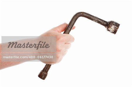 Hand with a old wrench isolated on white