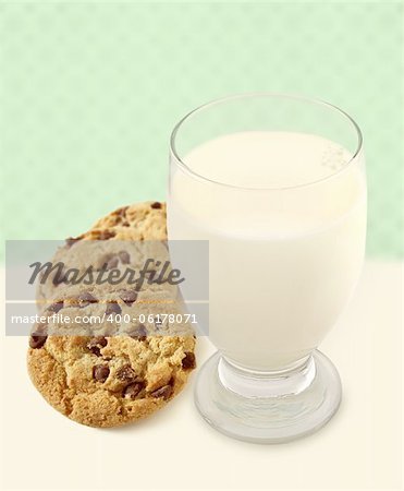 Chocolate Chip Cookies and a glass of Milk with mint green background. Shallow depth of field on cookies.