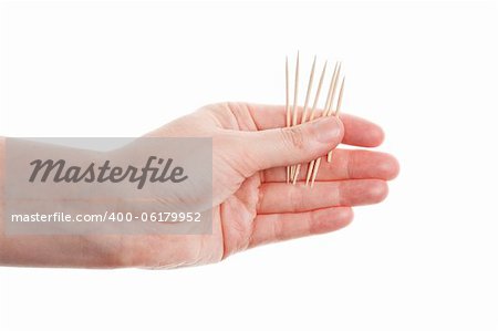 Toothpicks in hand isolated on white background