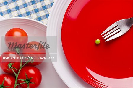 Directly above photograph of red tomatoes and a green pea.