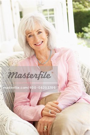 Portrait Of Senior Woman Relaxing In Chair