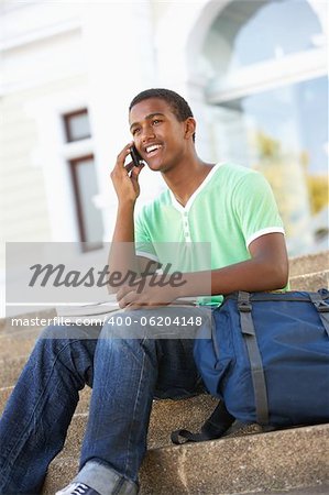 Male Teenage Student Sitting Outside On College Steps